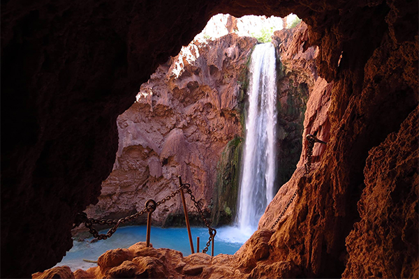 a view of Mooney Falls from the trail down to its base